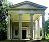 A classical portico with four columns and the entrance to the church beyond