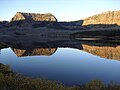 A September sunrise highlights the basalt cliffs above Trappers Lake.