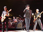 Colour photograph of U2 performing live in 2005.