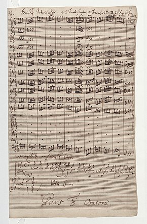 first page of the score in Bach's handwriting, with the instrumental beginning of the first chorus, and below the beginning of the first recitative