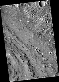 Northeastern Henry crater showning layers at lower left and linear hills called yardangs, sculpted by wind