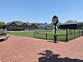 Front Lawn courts with indoor tennis club and outdoor hard courts in background.