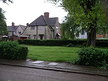 Larkin's parents' former Radford council house overlooks a small spinney, once their garden. The spinney is on the corner of two roads. It is a lawn, maintained by the Coventry City Council groundsmen, with some mature trees and bushes around the perimeter as seen in 2008