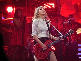 Swift performing on a red guitar