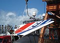 The tail fin of the Airbus A330 that crashed as Air France Flight 447 is being loaded onto the frigate