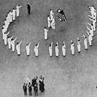 Bellamy salutes in 1917 at a Fifth Avenue ceremony opposite the Union League Club reviewing stand during the recent "Wake Up, America!" celebration where thousands marched in the procession.