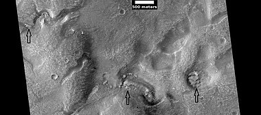 Layered features in channels and depressions, as seen by HiRISE under HiWish program. Arrows point to some of the layered features.