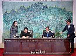 Kim Jong-un and Moon Jae-in seated at a table