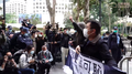 LSD member Leung Kwok-hung and Raphael Wong protesting outside the Court of Final Appeal while holding up banners.