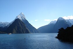 Blue water against a backdrop of snow-capped mountains