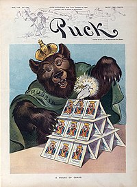 The image shows a bear behind a house of cards