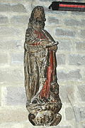 Photographie d’une statue de saint Luc rédigeant l’évangile, en bois sculpté du XVIIe siècle.