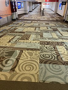 A hallway in 2021 within Nashville International Airport, carpeted entirely using the old design.