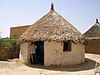 Earthen hut with thatched roof in Toteil, near Kassala, Sudan