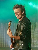 A smiling John Taylor on stage