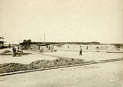 c. 1900–1910 a drying area: One firing pile is being prepared; another is under way.