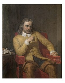 A portrait of Oliver Cromwell, seated, wearing a yellow shirt with his fist raised.