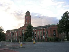 Wide, two storey brick building with central tower