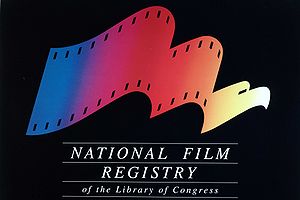 The image includes a logo on a black background. The logo looks like a film reel and changes from left-to-right to an eagle. The logo is multi-colored and below it is the phrase "National Film Registry of the Library of Congress".