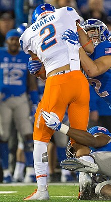 Shakir jumping in the air while playing football