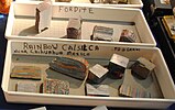 Raw and unpolished fordite on display above rainbow calsilica, which is meant to emulate fordite, 2016