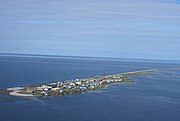 Aerial photo of Kivalina, Alaska showing its proximity to sea level and potential for flooding and being submerged