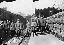 B&W photo of a man inspecting men wearing uniforms