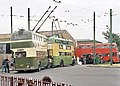 Trolleybuses at the museum. The rear (dark green and cream) vehicle is from Derby and the front (light green and yellow) vehicle is from Wolverhampton. The red bus in the distance is a BMMO motor bus.