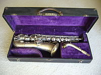 A straight-necked Conn C melody saxophone (Conn New Wonder Series 1)[53] with a serial number that dates manufacture to 1922