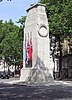 A large Portland stone cenotaph draped in flags, bearing inscription, 'The Glorious Dead'