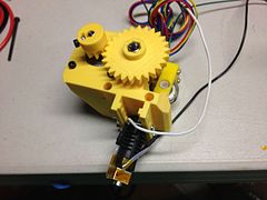 The original Prusa i3 MK0 extruder and hot end with yellow printed parts.