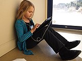 An elementary school student completing schoolwork on an iPad, 2011. Generation Z was among the first cohorts to use mobile devices in education.