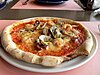 A seafood pizza with clams, shrimp and octopus