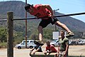 Matthew Lefave flips over an obstacle course bar during event 3.