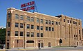 Flatiron-shaped brick building with "Walker Theatre" in large red letters