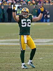A picture of Clay Matthews in uniform on the field with his hands in the area, presumably to pump up the home-team crowd