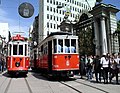 Nostalgic tram passing in front of gates of Galatasaray High School on Istiklal Caddesi in Istanbul