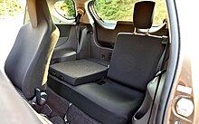 Rear bench seat with one half of the backrest folded down to allow for additional luggage space