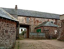 Old stone building with archway.