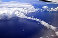 Cumulus cloud bow above the Pacific Ocean with low stratocumulus in the background.