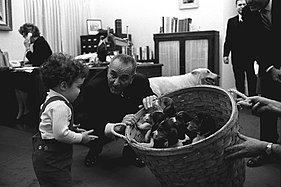 President Lyndon B. Johnson with a basket of puppies in 1966