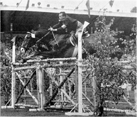 Jesús Rivas jumping a fence on a horse