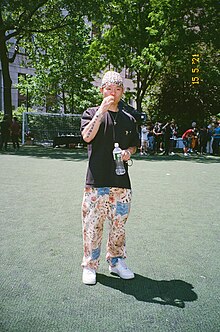 Rapper Bohan Phoenix stands in a park in Chinatown, Manhattan.