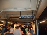 C train stop sign in front of a staircase to the station house