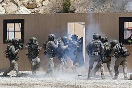 A GIGN assault team entering a kill house after breaching its door - 2022