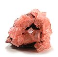 Image 18Pink cubic halite (NaCl; halide class) crystals on a nahcolite matrix (NaHCO3; a carbonate, and mineral form of sodium bicarbonate, used as baking soda). (from Mineral)