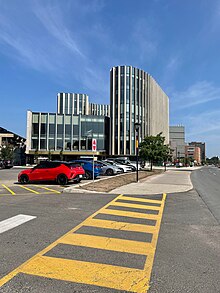 a photo leading up the sidewalk to the Nicol Building