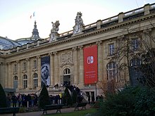 The Grand Palais of Paris is seen with a large Nintendo Switch banner advertisement hanging from it.