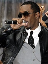 Sean Combs (P. Diddy/Puff Dady) wearing sunglasses while singing into a microphone