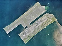 A satellite image of an artificial island in use as an airport. Several runways are visible.